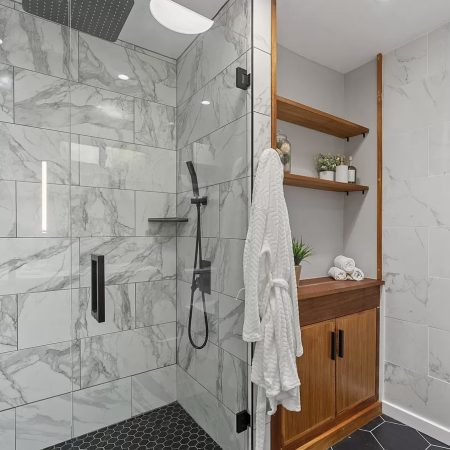 Frameless-shower-white-tile-natural-wood-linen-cabinet.jpg